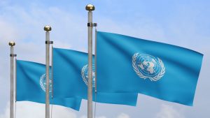 3d United Nations Flag Waving Wind With Blue Sky Clouds Close Up Un Banner Blowing Soft Smooth Silk Cloth Fabric Texture Ensign Background